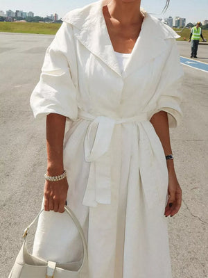 White lapel collar midi dress with tie waist and cuffed sleeves.
