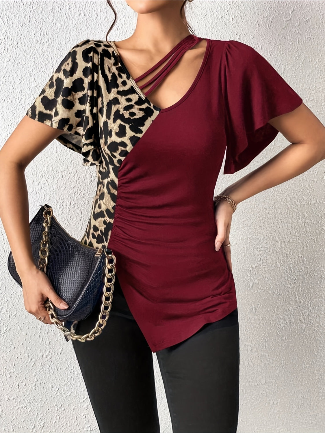 Burgundy and leopard print asymmetric top with ruched side and cutout neckline.