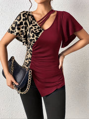 Burgundy and leopard print asymmetric top with ruched side and cutout neckline.
