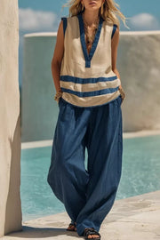 Flowy pants and striped V-neck sleeveless top in Dusty Blue and beige polyester ensemble.