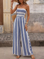 Strapless wide-leg romper with blue geometric print and smocked bodice.
