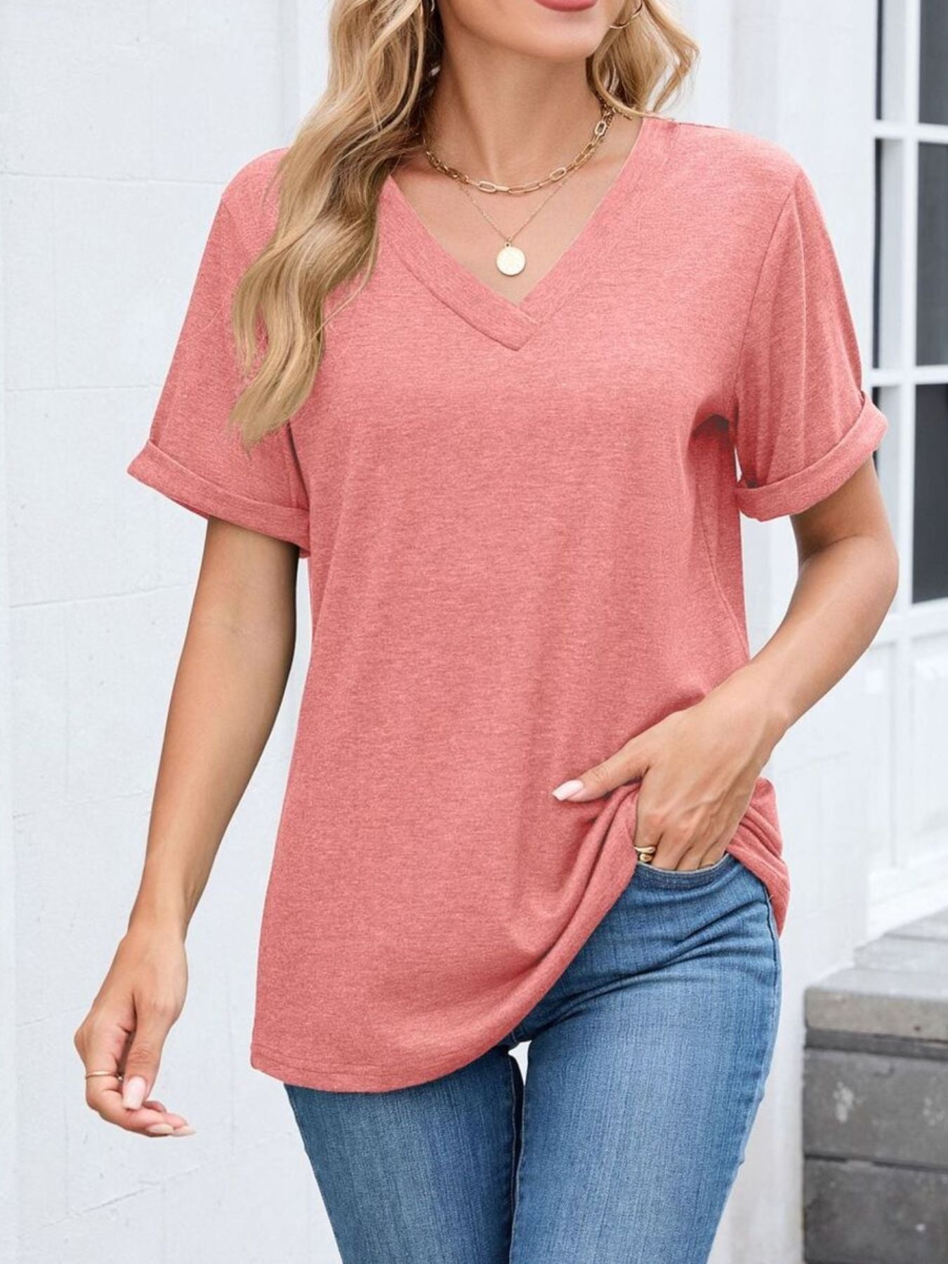 Pink v-neck t-shirt with cuffed short sleeves and a relaxed fit.