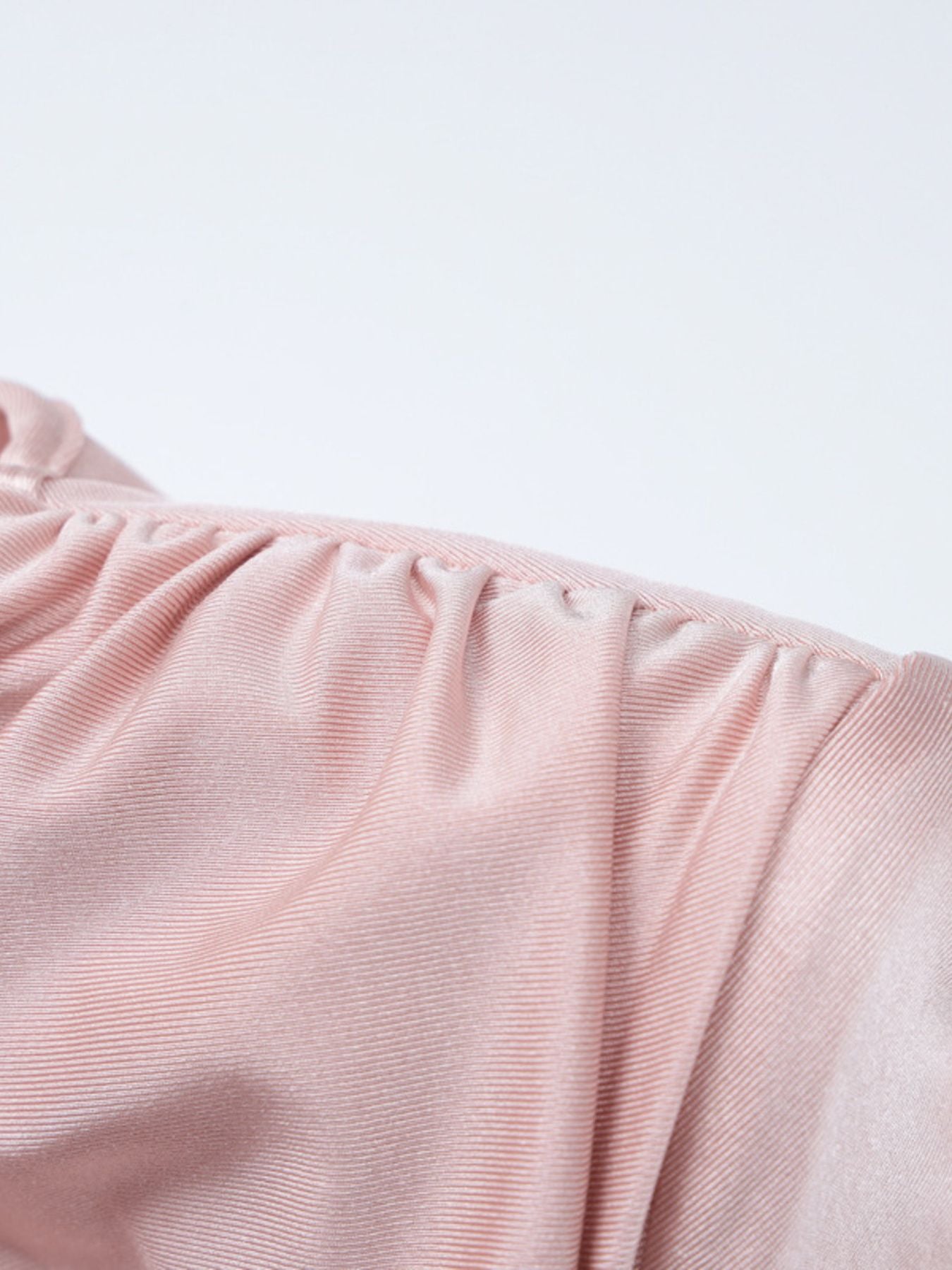 Pink ruched knot front maxi dress detail showing gathered neckline and textured fabric.
