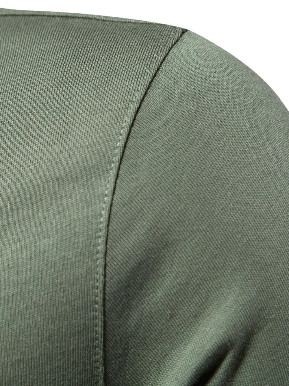Moss green cotton polo shirt detail showing textured fabric and stitching.