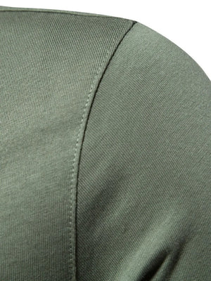 Moss green cotton polo shirt detail showing textured fabric and stitching.