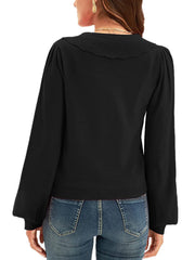 Black knit cardigan with scalloped collar and puff sleeves