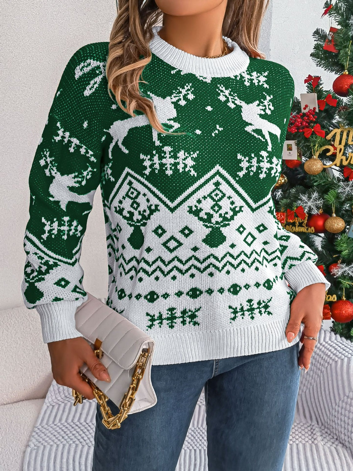 Green acrylic knit sweater with reindeer and snowflake Fair Isle pattern.