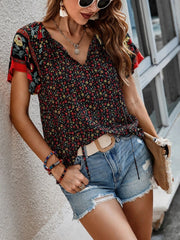 Bohemian floral print blouse with flutter sleeves and V-neck in multicolor.