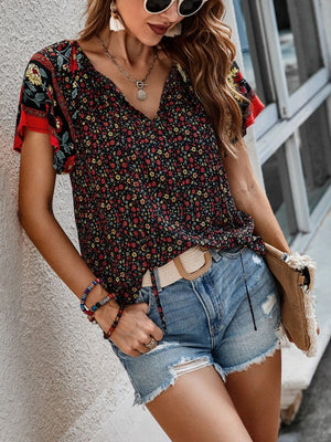 Bohemian floral print blouse with flutter sleeves and V-neck in multicolor.