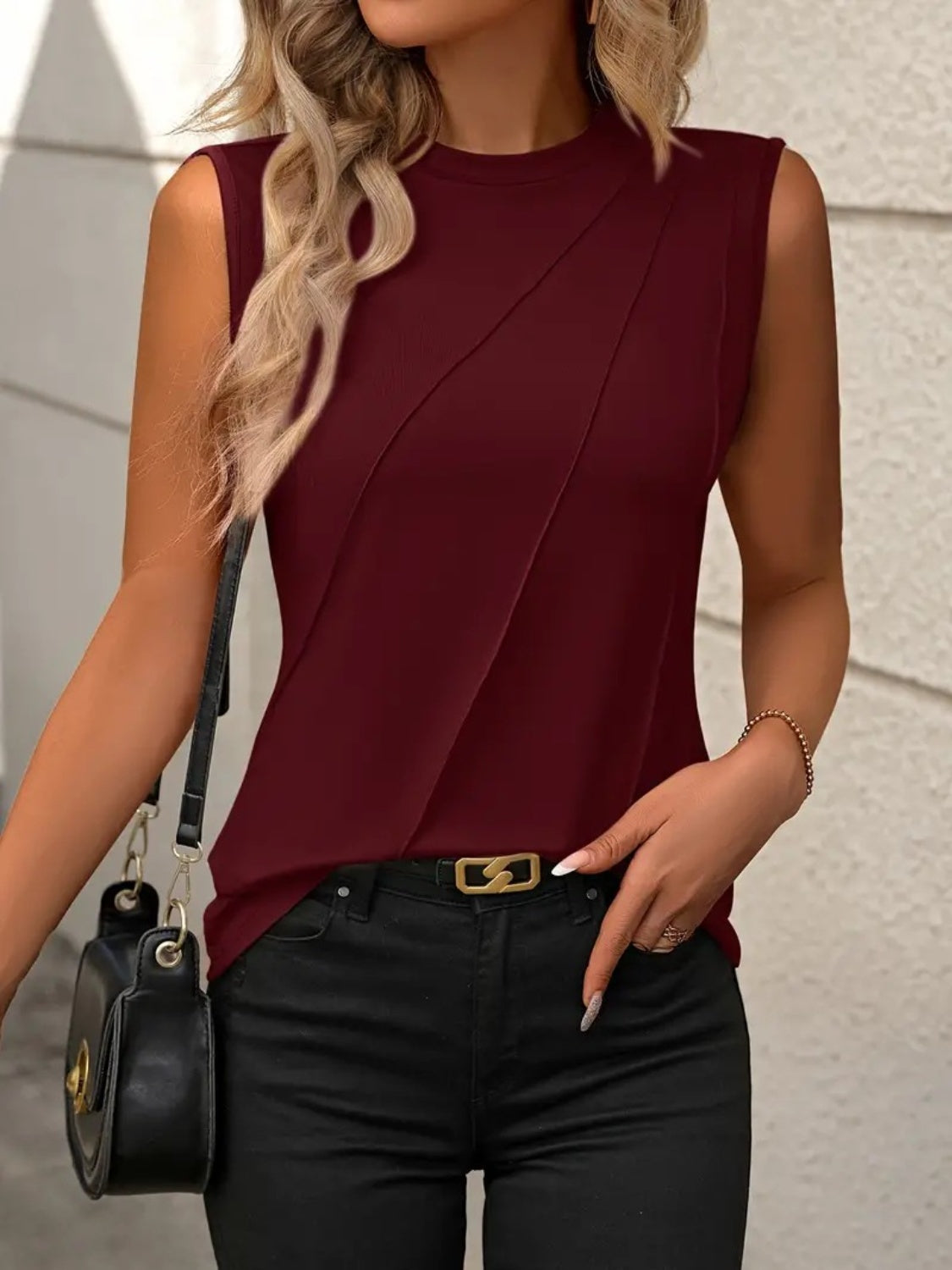 Burgundy sleeveless top with diagonal seam detail and crew neck.