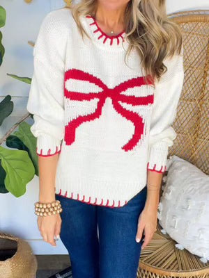 Ivory knit sweater with red bow detail and contrast stitching.