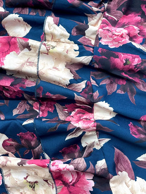 Ruffled floral two-piece set in navy with pink and cream peonies, polyester fabric.