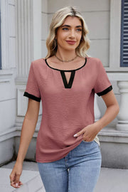 Dusty pink blouse with black contrast trim and keyhole neckline.
