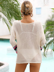 Cream crochet cover-up with rainbow stripe bell sleeves and open knit detail.