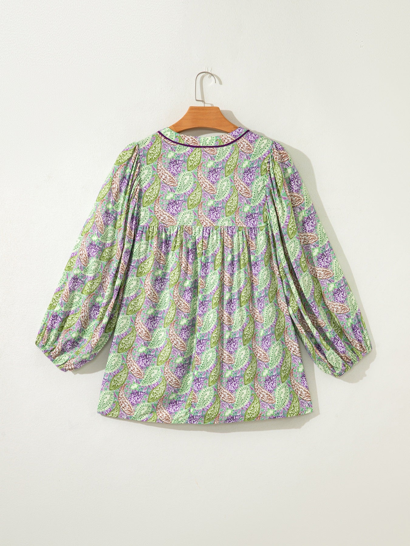 Paisley print puff sleeve blouse in green and purple with a gathered neckline and purple trim.