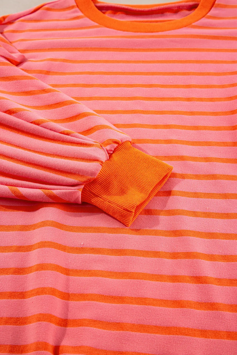 Chevron-Inset Stripe Sweatshirt in pink and orange horizontal stripes with orange cuffs.