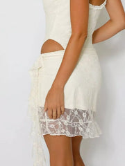 Lace ruffled mini skirt in white with asymmetrical hem and delicate lace trim.