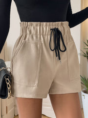 Tan paperbag waist utility shorts with drawstring and large front pockets.