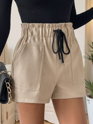 Tan paperbag waist utility shorts with drawstring and large front pockets.