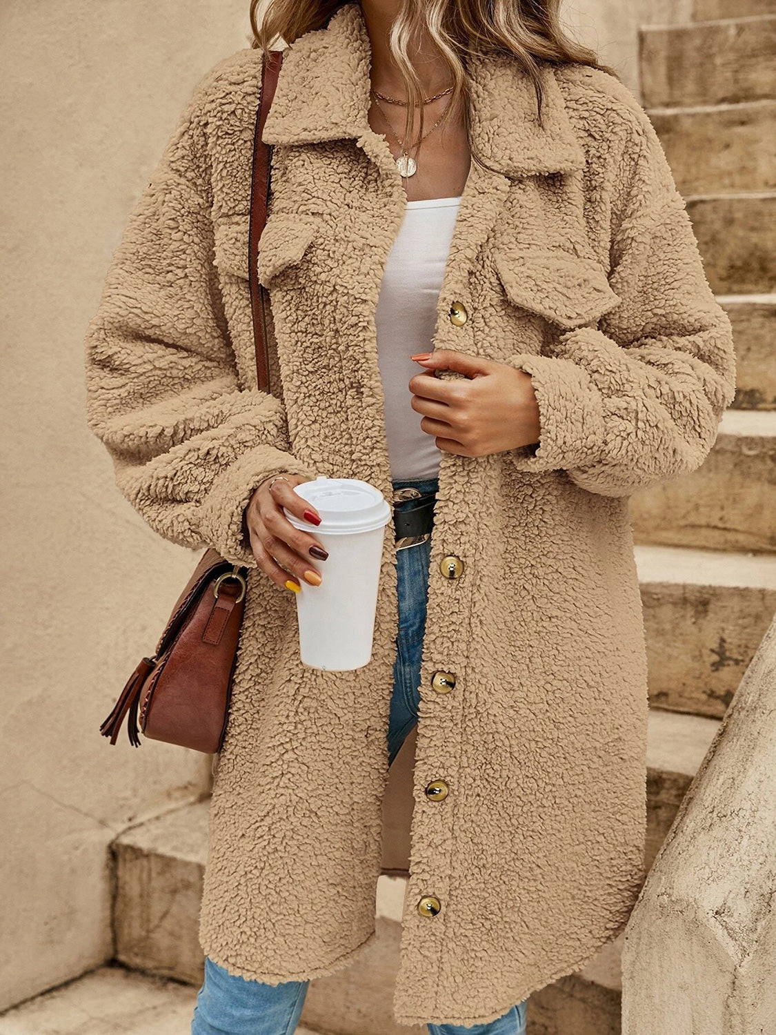 Oversized tan teddy bear shacket with button-down front and chest pockets.