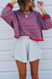 Ribbed contrast trim sweatshirt with red and blue stripes and red cuffs.