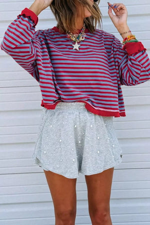 Ribbed contrast trim sweatshirt with red and blue stripes and red cuffs.