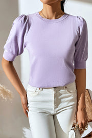 Lilac knit sweater with puff sleeves and crew neck.