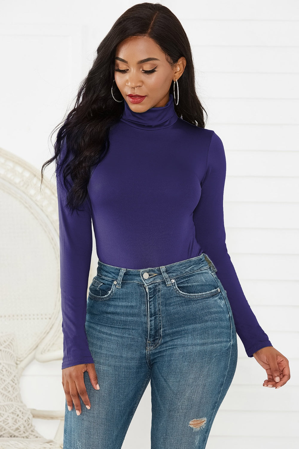 Royal Blue turtleneck thong bodysuit with long sleeves, styled with high-waisted jeans.