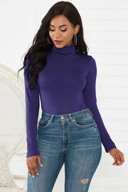 Royal Blue turtleneck thong bodysuit with long sleeves, styled with high-waisted jeans.