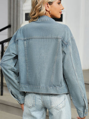 Light wash denim box jacket with pearl embellishments and buttoned cuffs.