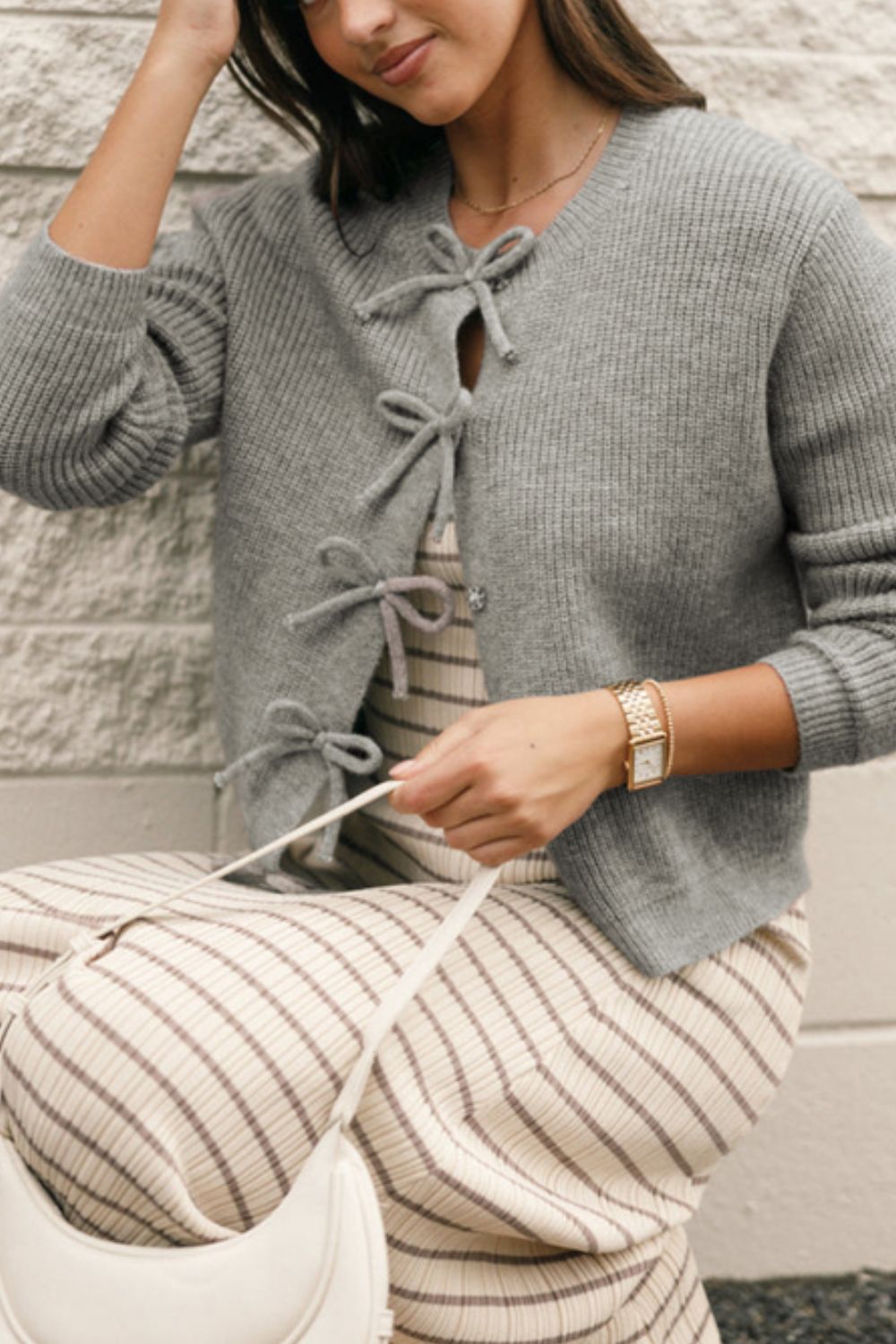 Gray ribbed knit cardigan with tie-front detail and V-neckline.