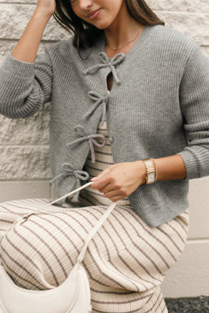 Gray ribbed knit cardigan with tie-front detail and V-neckline.