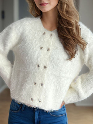 Fluffy white double-breasted knit cardigan with silver buttons.
