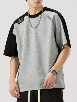 Gray and black color block cotton blend t-shirt with round neck and short sleeves.