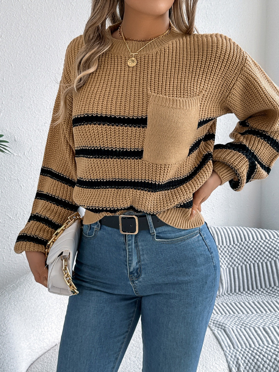 Caramel knit sweater with black stripes and a chest pocket.