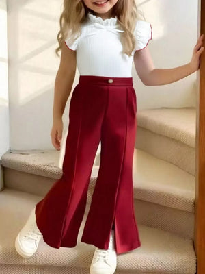 Baby girl's white ruffle top with red trim and wine red flare pants with slit hem.