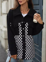 Black button-up jacket with checkerboard panels and chest pockets.