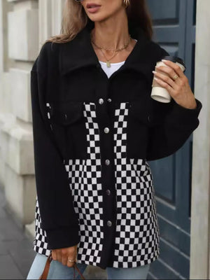 Black button-up jacket with checkerboard panels and chest pockets.