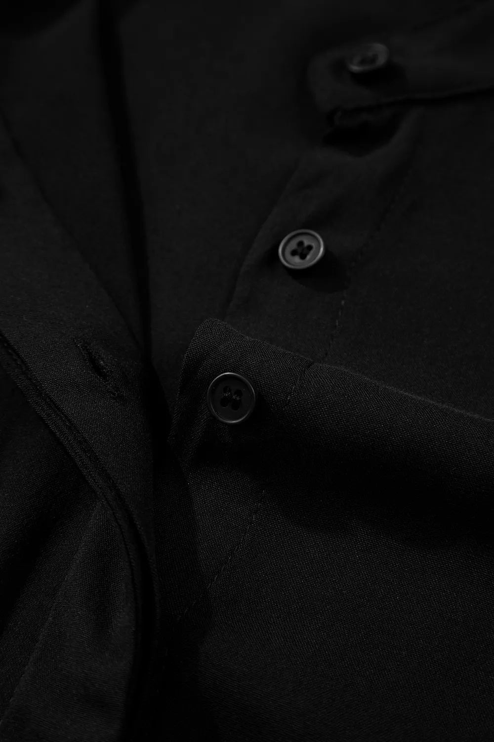 Black maternity maxi dress detail showing buttons and fabric texture