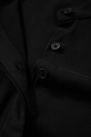 Black maternity maxi dress detail showing buttons and fabric texture