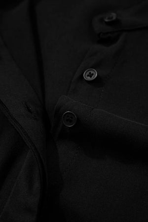 Black maternity maxi dress detail showing buttons and fabric texture