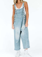 Light blue ripped relaxed fit denim overalls with adjustable straps and button sides.