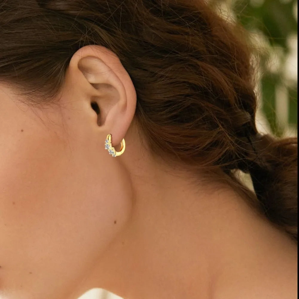 Gold pavé mini hoop earrings with clear stones.