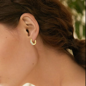 Gold pavé mini hoop earrings with clear stones.