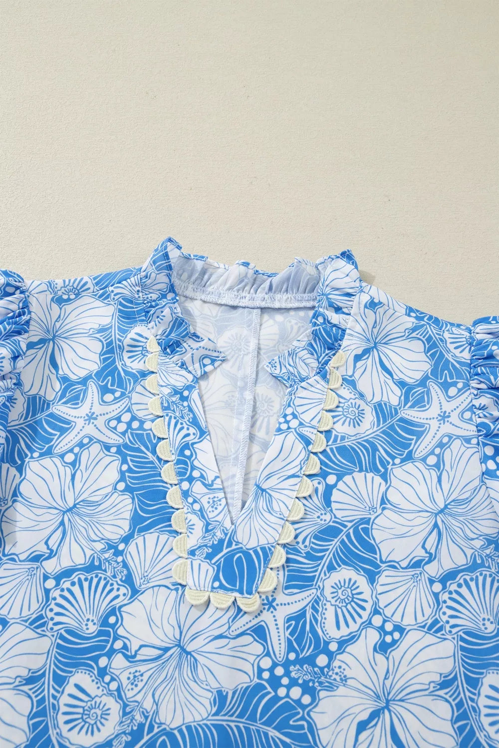 Tropical floral v-neck blouse with frill trim and puff sleeves in blue and white polyester