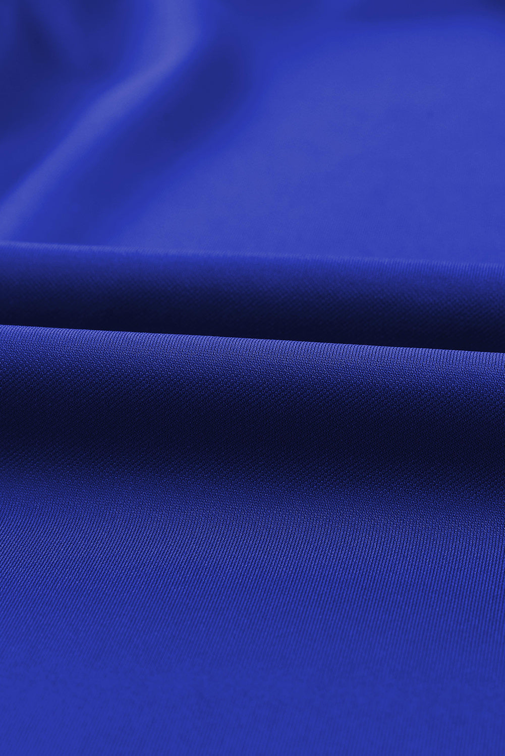 Royal blue jumpsuit fabric detail with subtle texture