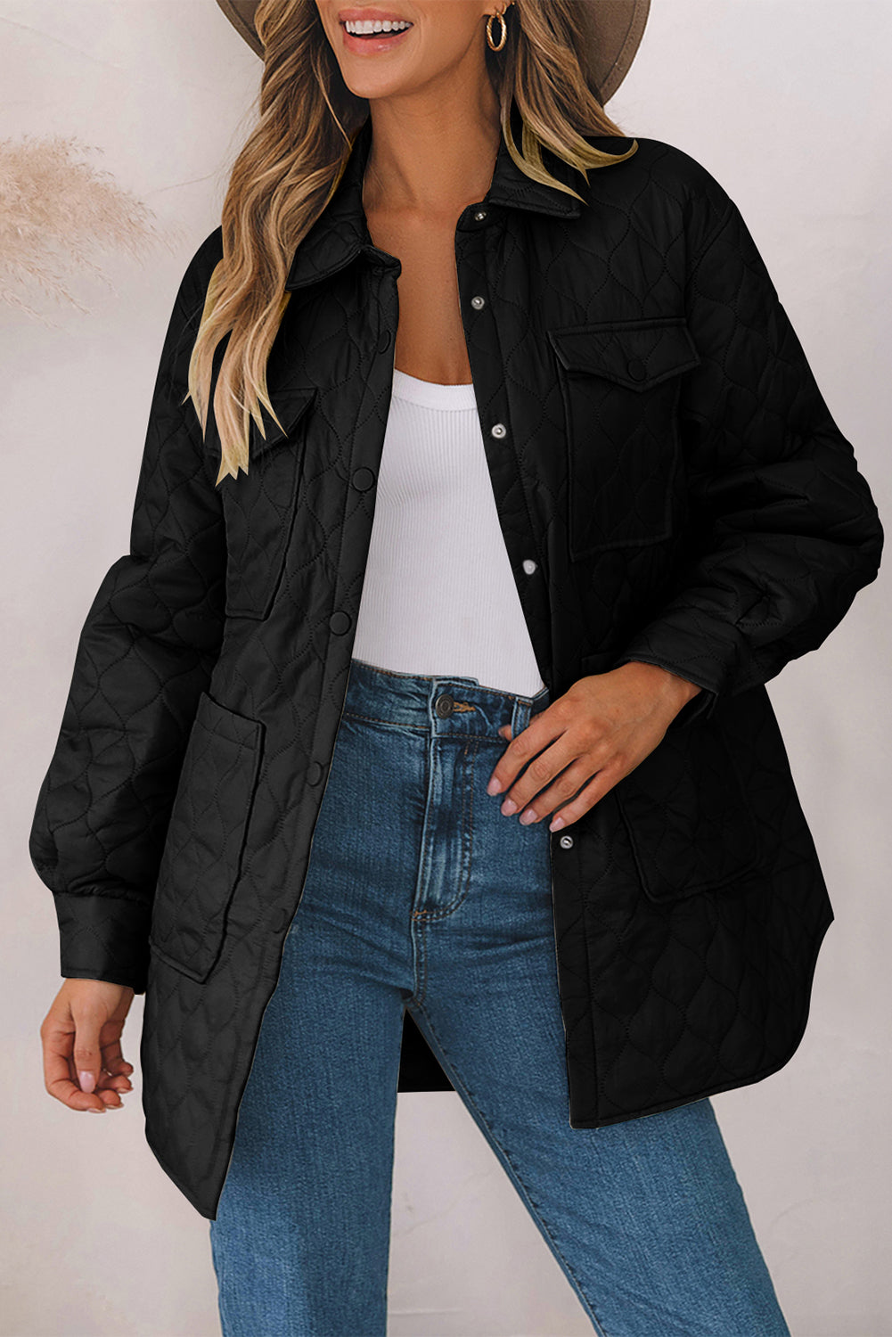 Black quilted utility jacket with snap front and chest pockets