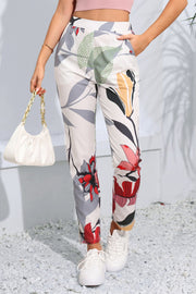 Botanical print slim-fit trousers in floral pattern, featuring a high waist and tapered leg.