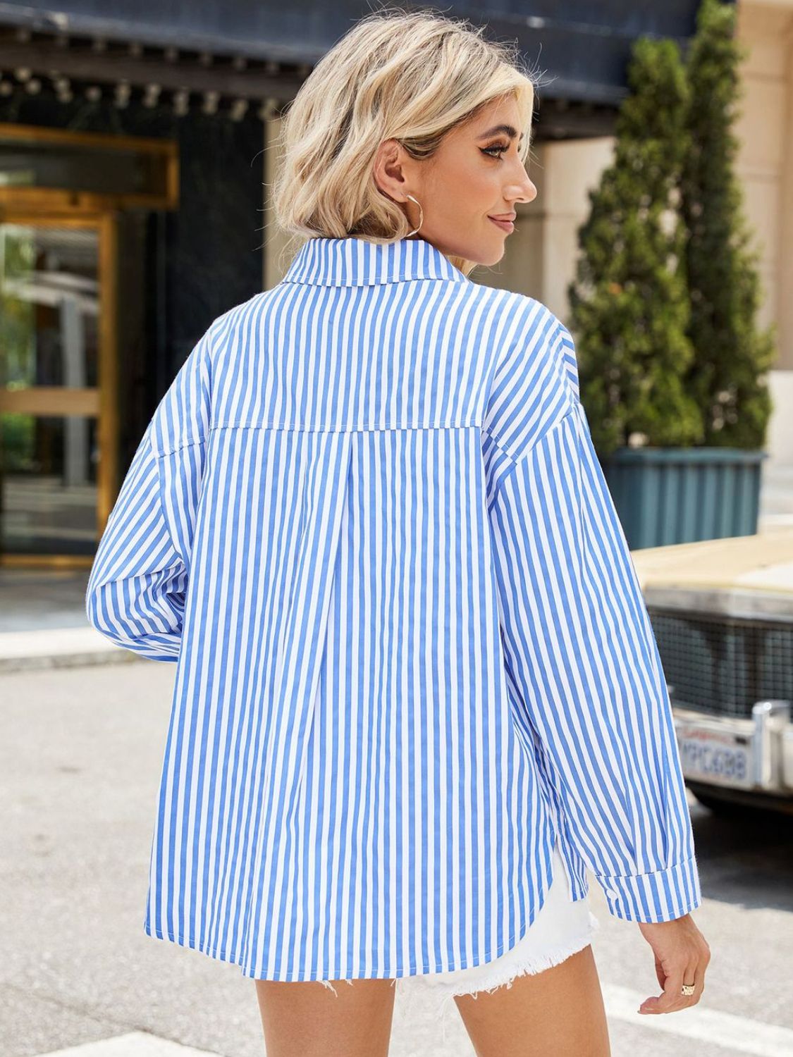 Sky blue and white striped oversized button-up shirt with a tie-front detail.