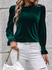 Dark green velvet blouse with blouson sleeves and ruffled cuffs.